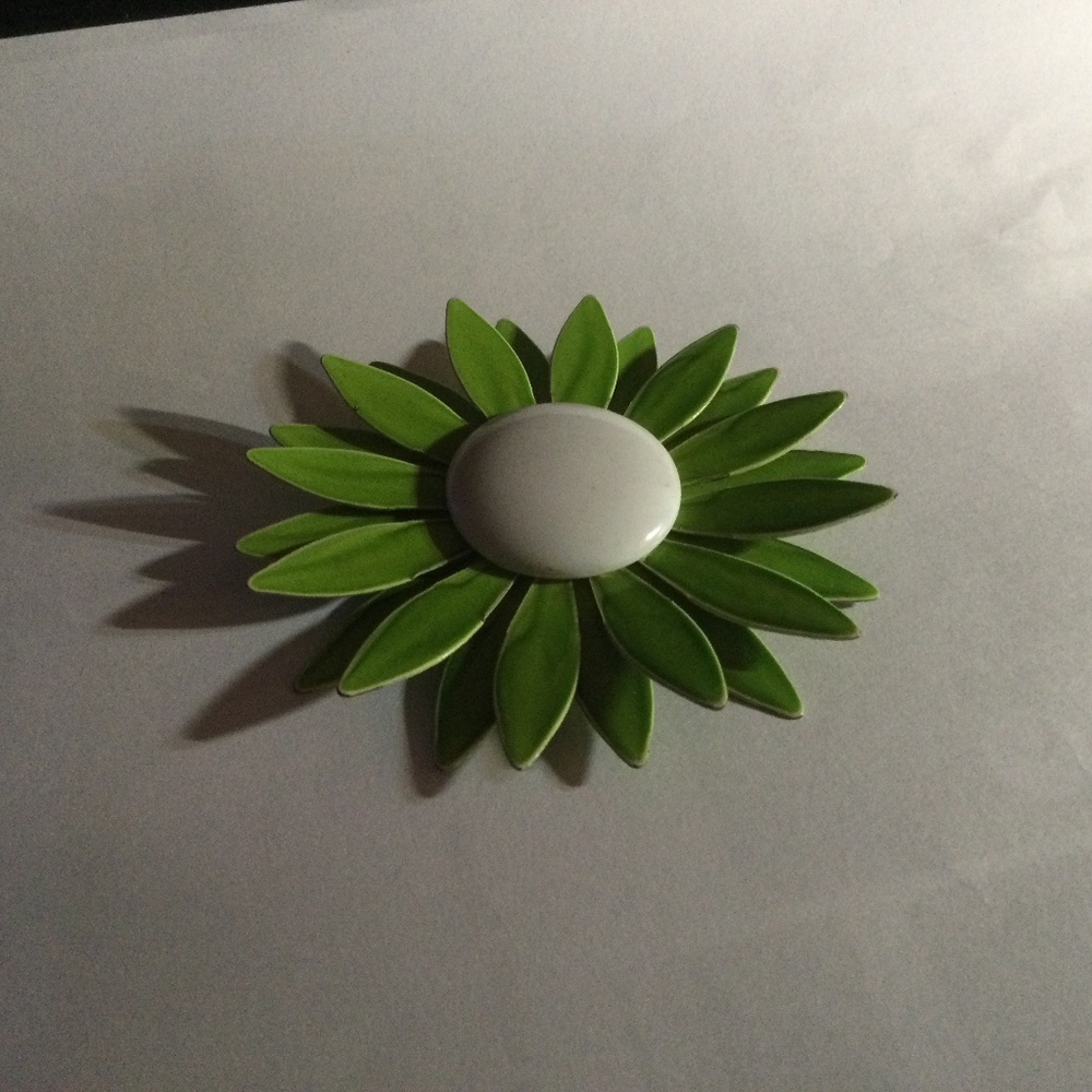 Retro green and white enamel pin.